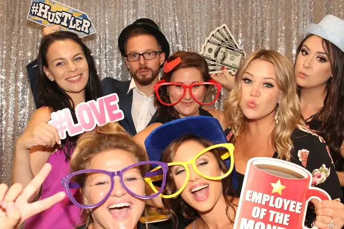 Guests posing with props at a Rent a PhotoBooth photo booth